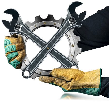 Manual worker with work gloves holding a metallic cogwheel (metal gear) with two modern stainless steel adjustable wrenches, isolated on white background with reflection.の写真素材