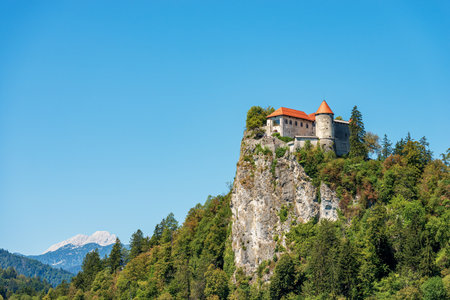 Medieval Bled Castle (Blejski grad), XI century, coast of the Lake Bled (Blejsko jezero). Bled town, Gorenjska, Triglav National Park, Slovenia, Europe. On background, the peak of Triglav or Tricorno.のeditorial素材