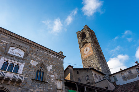 Historic palaces in the upper town of Bergamo, Palazzo del Podesta, XII century with the bell tower called Campanone and the Palazzo della Ragione, 1183-1198. Piazza Vecchia, Lombardy, Italy, Europe.のeditorial素材