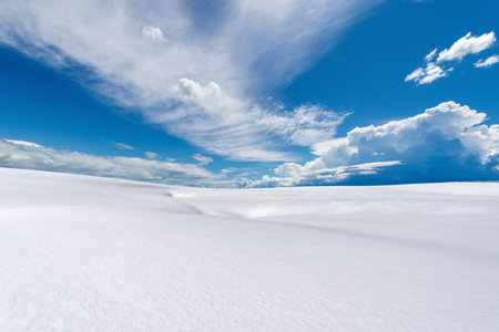Winter landscape with powder snow against a blue sky with clouds. Lessinia Plateau (Altopiano della Lessinia), Regional Natural Park, Verona Province, Veneto, Italy, Europe.の写真素材