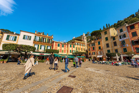 Group of tourists in the famous village of Portofino on a sunny spring day, luxury tourist resort in Genoa Province, Liguria, Italy, Europe.のeditorial素材