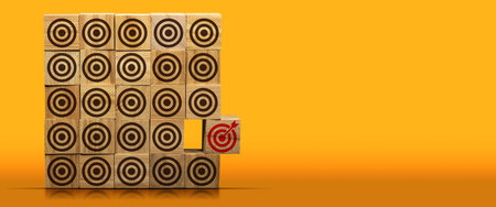 Stack of wooden blocks with many empty brown targets and one red one with an arrow reaching into the center, on a yellow and orange background with copy space and reflections.の写真素材