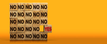 Stack of wooden blocks with text Yes or No. On a yellow and orange background with copy space and reflections.の写真素材