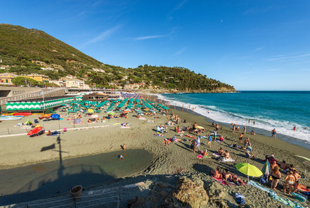 Bonassola beach crowded with tourists on a sunny summer day, small town and tourist resort in Ligurian coast. La Spezia province, Liguria, Italy, Europe.のeditorial素材