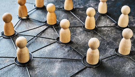 Close-up of a group of wooden figurines of people connected by black lines in a network. Communication and social networks, cooperation and collaboration concept. Generative Ai.の素材