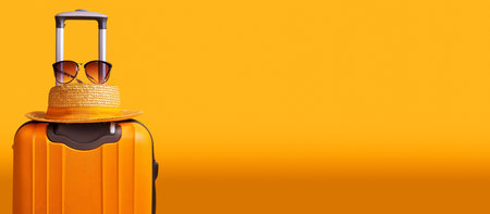 Orange and black suitcase or luggage bag with straw hat and sunglasses against a yellow-orange background with copy space. Holidays, weekend activities, relaxing time, traveling concept. Generative Aiの素材