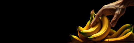 Extreme close up of a male hand takes ripe yellow bananas from the store shelf, isolated on a black background with copy space, shopping concept, wide blank banner. Generative Ai.の素材