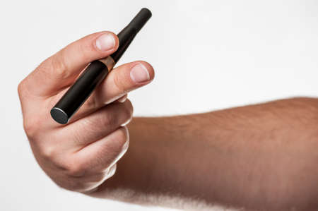 Man showing an electronic cigar in his handの写真素材