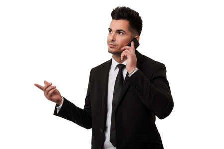 Handsome businessman talking on the phone with a clientの写真素材