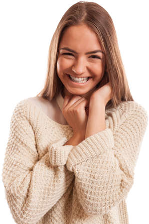 Young woman with a perfect smile wearing a knitted blouse and isolated on whiteの写真素材
