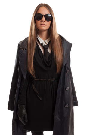 Undercover special agent dressed with a leather coat, leather gloves, black tie, and sunglasses の写真素材