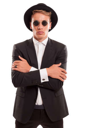 Young male model, shaved, and wearing a fancy hat and round sun glasses something like 60's fashion styleの写真素材