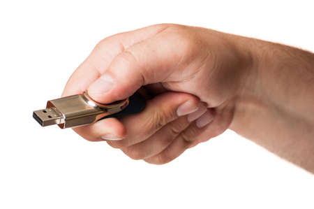 Hand and an usb flash drive isolated on a white backgroundの写真素材