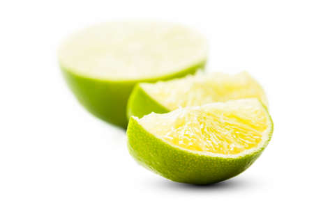 Closeup of a sliced lime, isolated on white background