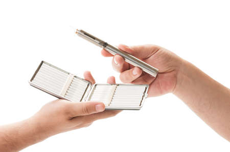 Cigarettes in a box versus electronic cigarette on white background