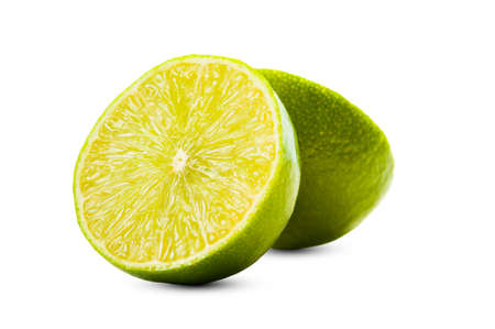 Closeup of a green fresh lime sliced in two, isolated on white backgroundの写真素材