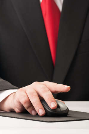 Closeup on a business man hand clicking a wireless mouse