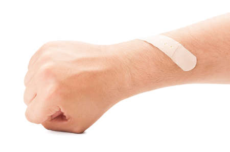 Wounded arm and patched concept on white background