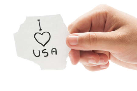 I love USA or America, concept  using a hand holding a small piece of paper on white backgroundの写真素材