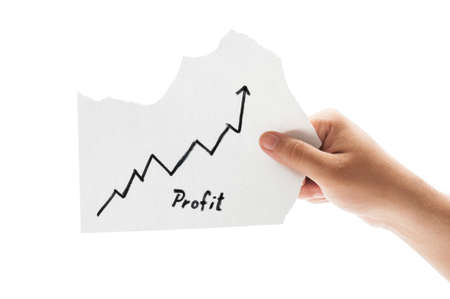 Growing profit chart concept using a hand holding a piece of paper and the text written by hand with a permanent markerの写真素材
