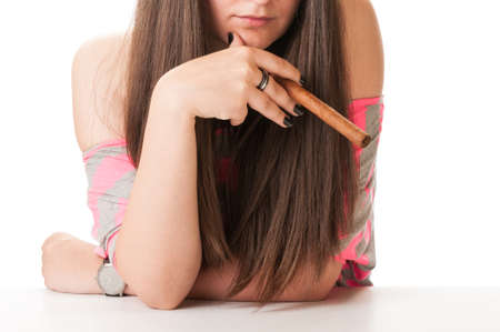Beautiful woman with long hair holding an original cuban cigarの写真素材