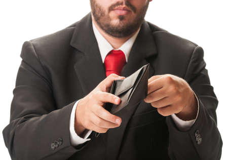 Business man with black suit and red tie looking into his black leather wallet