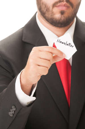 Newsletter concept using a man wearing a black suit and red necktie and holding a piece of paper with the text newsletter on it.の写真素材
