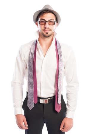 Two neckties hanging on male model wearing glasses and hat with white shirt and black pantsの写真素材