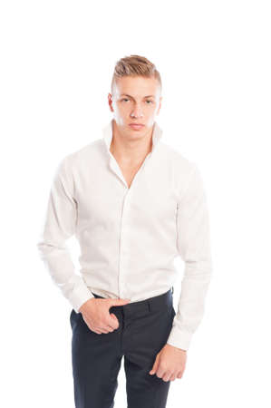 Blond male model wearing white shirt and back pants isolated on white studio backgroundの写真素材