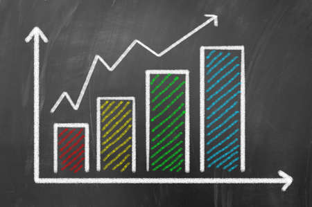Financial chart concept draws with colored chalk on blackboardの写真素材