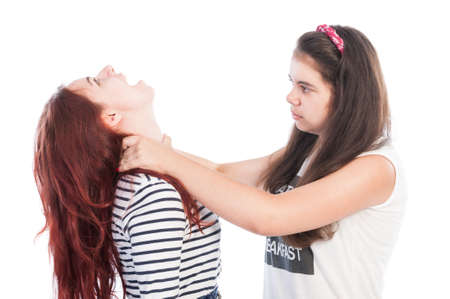Aggressive bullying girl strangling her friendの写真素材