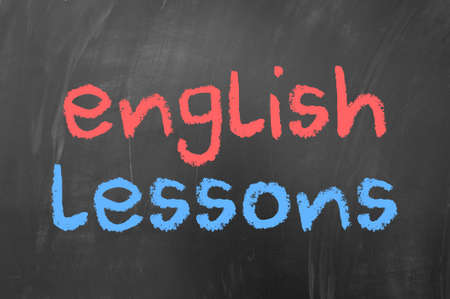 English lessons concept on blackboard with red and blue chalkの写真素材