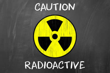 Caution Radioactive Symbol concept on blackboard