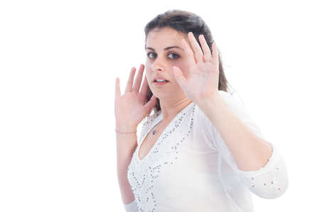 Scared girl protecting herself by raising arms