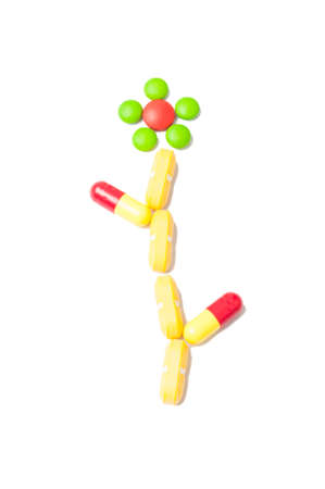 One medicine flower made from colored pills isolated on white backgroundの写真素材