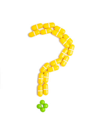 Question mark made from pills isolated on white background