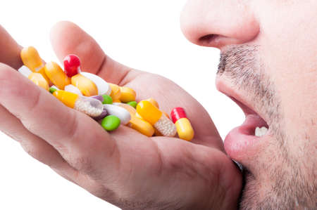 Man taking a lof of pills for his depressionの写真素材