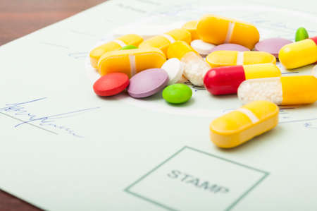 Closeup of some pills on a green medical prescriptionの写真素材