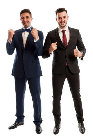 Successful business people smiling and holding fists upの写真素材
