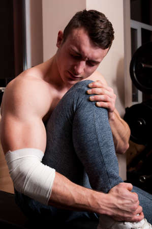 Body builder suffering after a gym injuryの写真素材