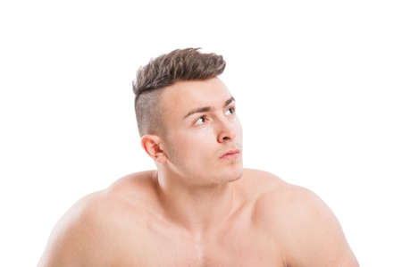 Portrait of a naked, muscular, young and handsome male model with copy space on white backgroundの写真素材