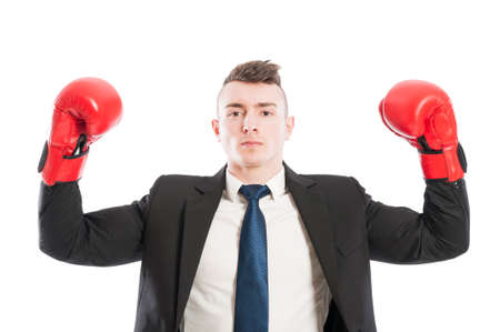 Successful business man lifting arms up as a champion or winner. Confident entrepreneur wearing red boxing gloves conceptの写真素材