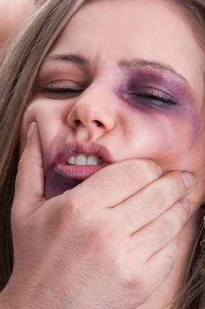 Scared woman getting beaten by aggressive man. Domestic violence concept with injuries and bruises