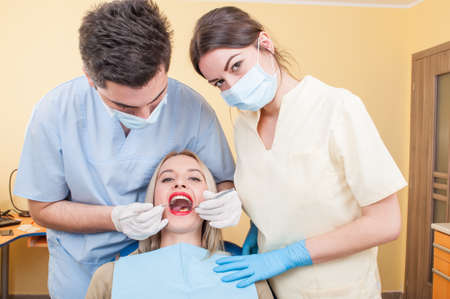 Dental team and beautiful female patient. Healthcare concept.の写真素材