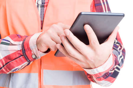 Constructor hand holding tablet and checking plans onlineの写真素材