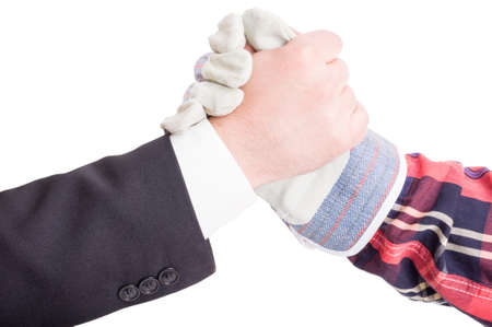 Professional builder and suited contractor arms wrestlingの写真素材