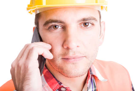 Modern constructor talking on his smartphone. Face closeup conceptの写真素材