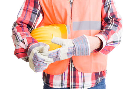 Builder or construction worker pulling out glove after work while holding helmet underarmの写真素材