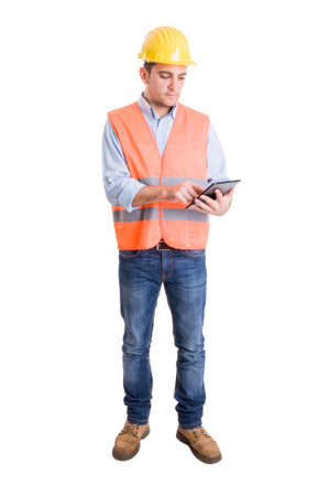 Modern engineer using a wireless tablet to check construction project or tasksの写真素材