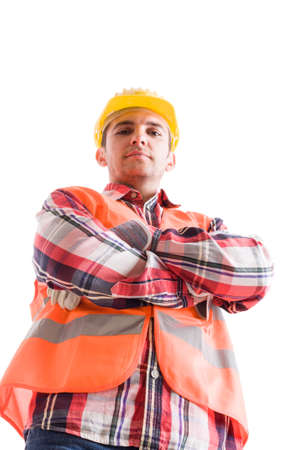 Confident builder or constructor from low angle with arms crossed